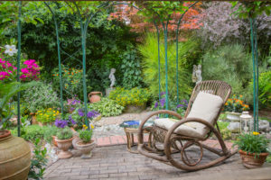 Garden terrace with rocking chair and various plants Garden terrace with rocking chair and various plants